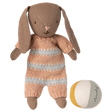 Maileg brown micro bunny plush toy wearing a dusty rose striped knit romper next to a small multicolored fabric ball.