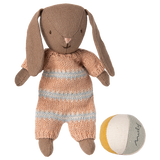 Maileg brown micro bunny plush toy wearing a dusty rose striped knit romper next to a small multicolored fabric ball.