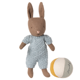 Brown Maileg micro rabbit plush wearing a light blue knitted romper standing next to a striped fabric toy ball.