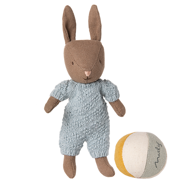 Brown Maileg micro rabbit plush wearing a light blue knitted romper standing next to a striped fabric toy ball.