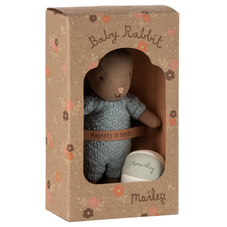 Maileg Baby Rabbit in blue knit suit and floral box. Small brown plush bunny toy with magnets in hands.