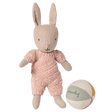 Maileg micro rabbit wearing a pink knitted suit standing next to a small fabric ball on a white background.