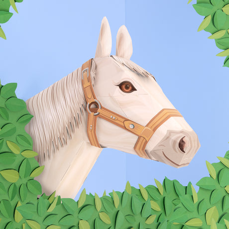 3D papercraft model of a white horse head with a bridle, framed by paper leaves against a blue background.