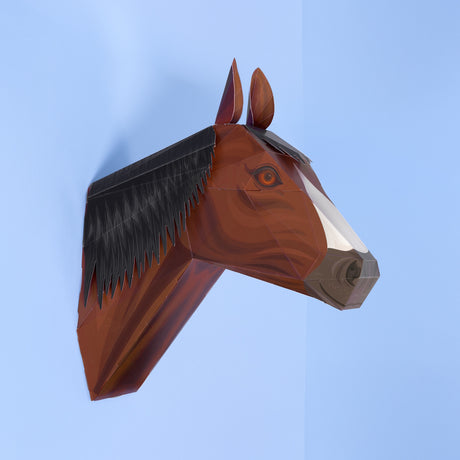 3D papercraft brown horse head mounted on a light blue wall.