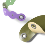 Colorful flexible plastic prop strips with grommet connectors on a white background.