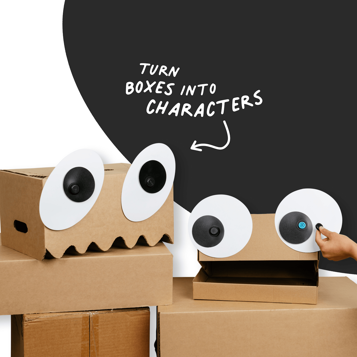 Cardboard box monsters with large googly eye cutouts attached using Makedo fasteners.