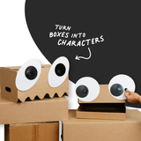 Cardboard box monsters with large googly eye cutouts attached using Makedo fasteners.