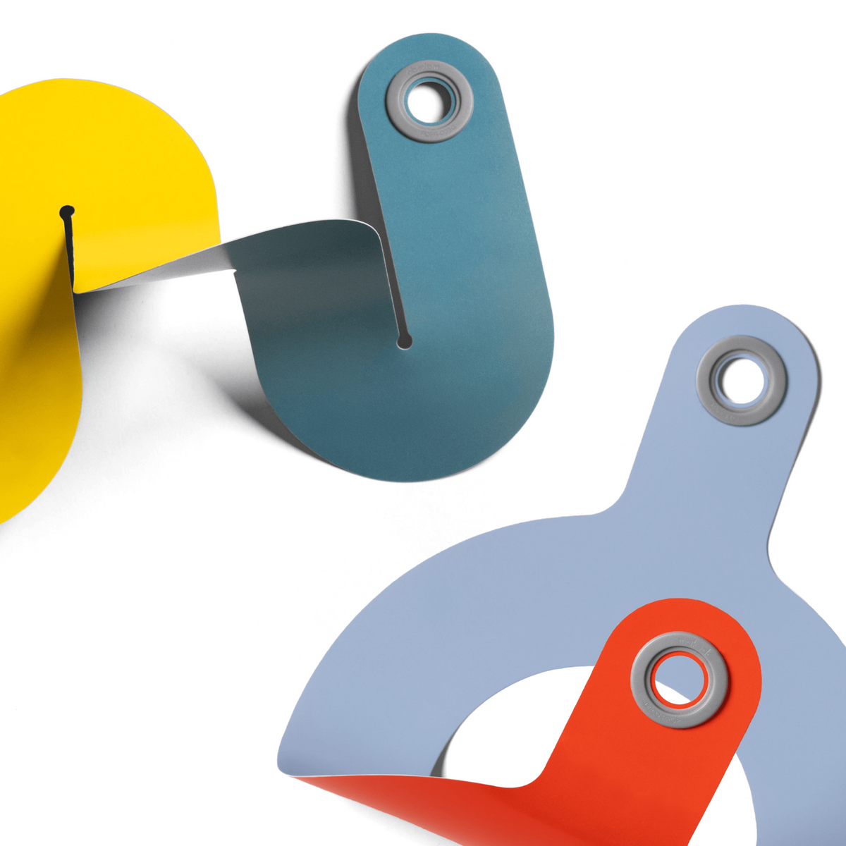 Colorful, curved paper craft shapes connected together with grey plastic eyelets against a white background.