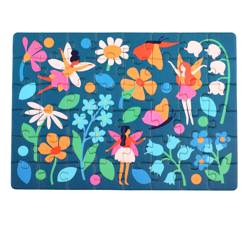 Colorful fairy-themed puzzle with 48 pieces, featuring vibrant flowers and whimsical fairies on a dark blue background, neatly packed in a matchbox-sized box.
