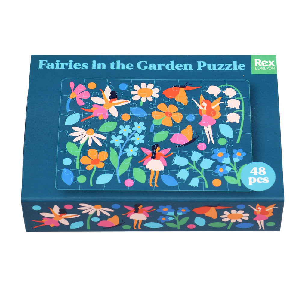 Colorful fairy-themed puzzle with 48 pieces, featuring vibrant flowers and whimsical fairies on a dark blue background, neatly packed in a matchbox-sized box.