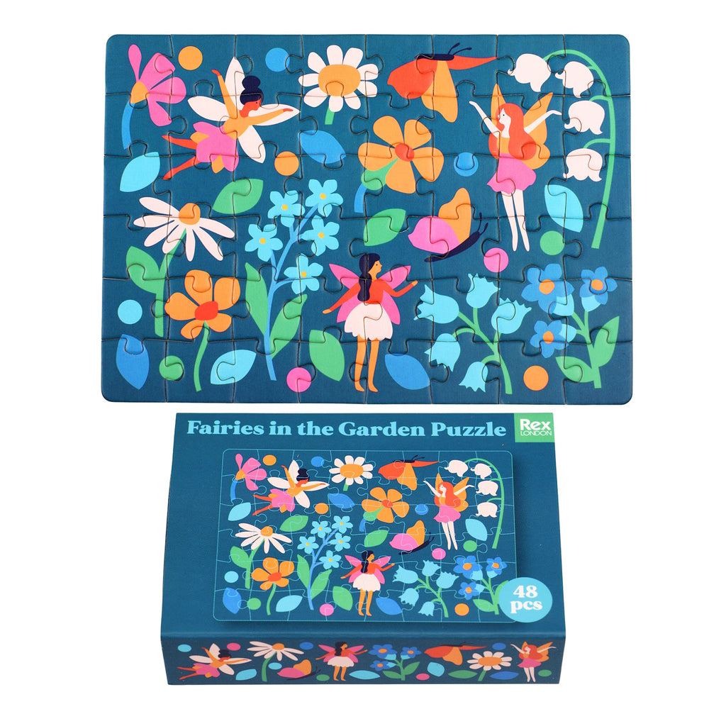 Colorful fairy-themed puzzle with 48 pieces, featuring vibrant flowers and whimsical fairies on a dark blue background, neatly packed in a matchbox-sized box.