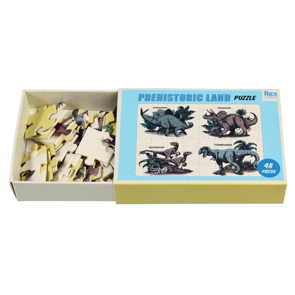 Colorful dinosaur puzzle featuring Stegosaurus, Triceratops, Velociraptor, and Tyrannosaurus, packed in a matchbox-sized box.