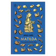 Blue clothbound book cover featuring gold illustrations of books and a girl sitting on a tall stack of books.