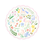 A round, scalloped paper plate with a pastel pattern of unicorns, flowers, and butterflies.