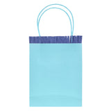 Light blue Meri Meri party bag with dark blue crepe paper fringe and blue twine handles on a white background.