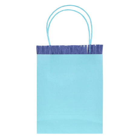 Light blue Meri Meri party bag with dark blue crepe paper fringe and blue twine handles on a white background.