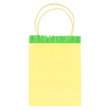 Yellow paper party gift bag with green fringed crepe paper trim and twisted paper handles.