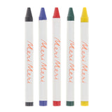 Five Meri Meri brand wax crayons in black, blue, red, green, and yellow on a white background.