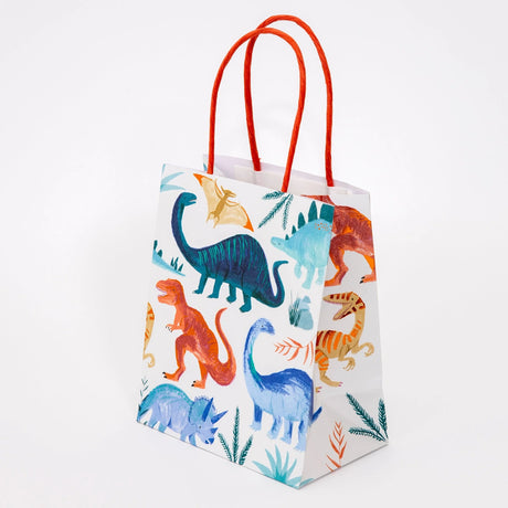 A dinosaur-themed party gift bag with bright orange handles, featuring watercolor illustrations of dinosaurs.