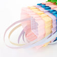 Pastel ruffled crepe paper Easter baskets with handles and gingham lining, perfect for spring party favors and gifts.