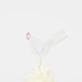 White paper hen cupcake topper with a pink comb on a wooden pick, set in white frosting. Simple Easter party decor.