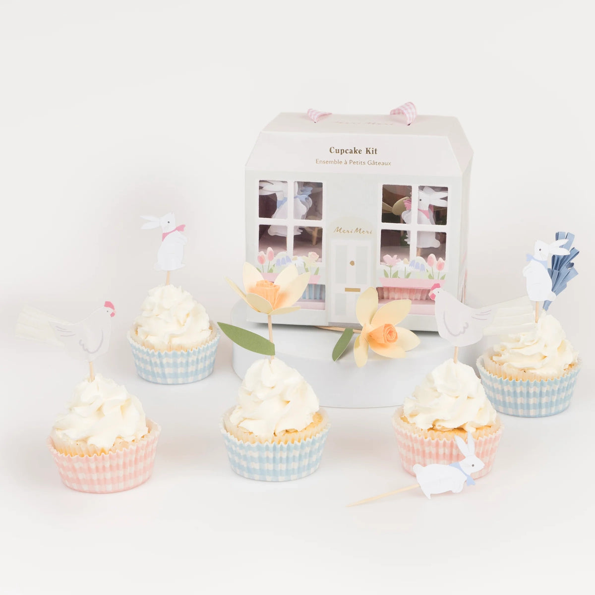 Meri Meri Easter Cottage Cupcake Kit featuring spring-themed toppers like bunnies and flowers with gingham liners.