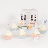 Meri Meri Easter Cottage Cupcake Kit featuring spring-themed toppers like bunnies and flowers with gingham liners.