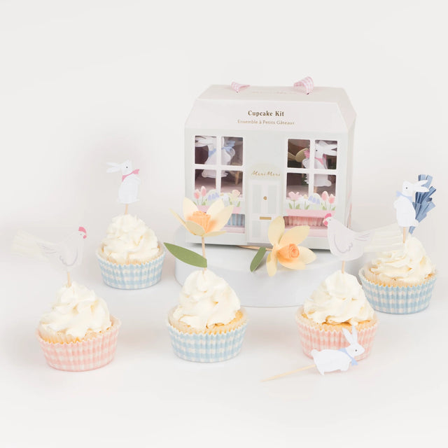 Meri Meri Easter Cottage Cupcake Kit featuring spring-themed toppers like bunnies and flowers with gingham liners.