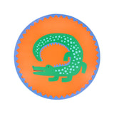 Green crocodile paper side plate with blue spots on an orange background, featuring a blue scalloped border.