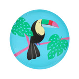Toucan paper side plate with colorful beak and green tropical leaves on a bright blue background.