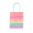 Rainbow fringed paper party bag with pastel tissue paper layers and mint green handles.