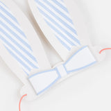 White and blue striped paper bunny ears with a matching bow tie and pink elastic string for Easter party costumes.