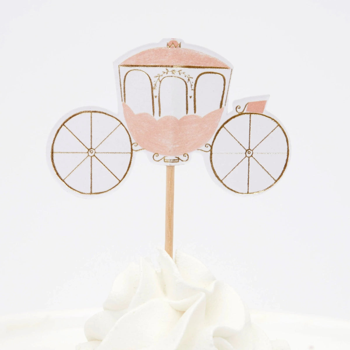 A pink and gold princess carriage cupcake topper with wheels, stuck into white frosting.