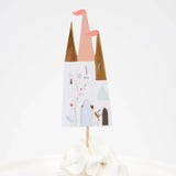 A castle-shaped cupcake topper with gold and pink turrets, decorated with floral illustrations on a white background.