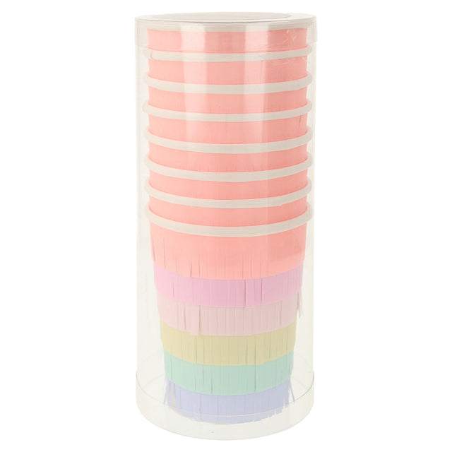 Stacked Meri Meri rainbow sun party cups with colorful fringe in a clear plastic cylinder for birthday party decorations.
