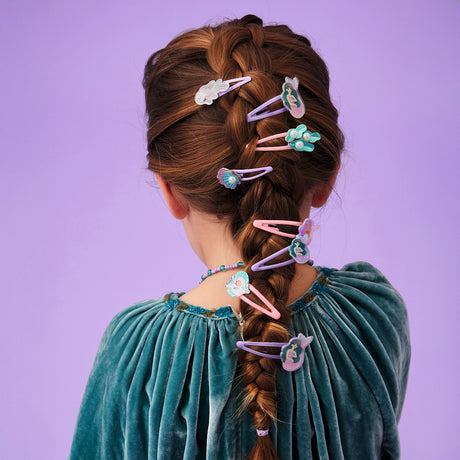 Girl wearing Marina mermaid collection snap hair clips set styled in a long braided hairstyle.