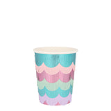 A pastel paper party cup decorated with colorful, scalloped fringe layers on a plain white background.