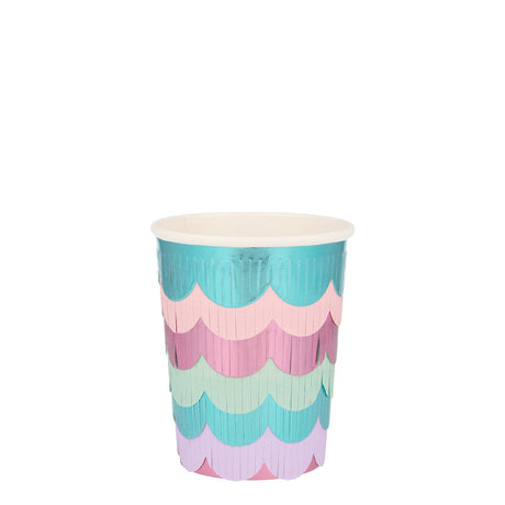 A pastel paper party cup decorated with colorful, scalloped fringe layers on a plain white background.