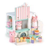 A wooden toy ice cream truck shown from the side with cat figures, cones, and milk cartons.