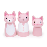 Three pink wooden cat figures standing side by side against a white background.