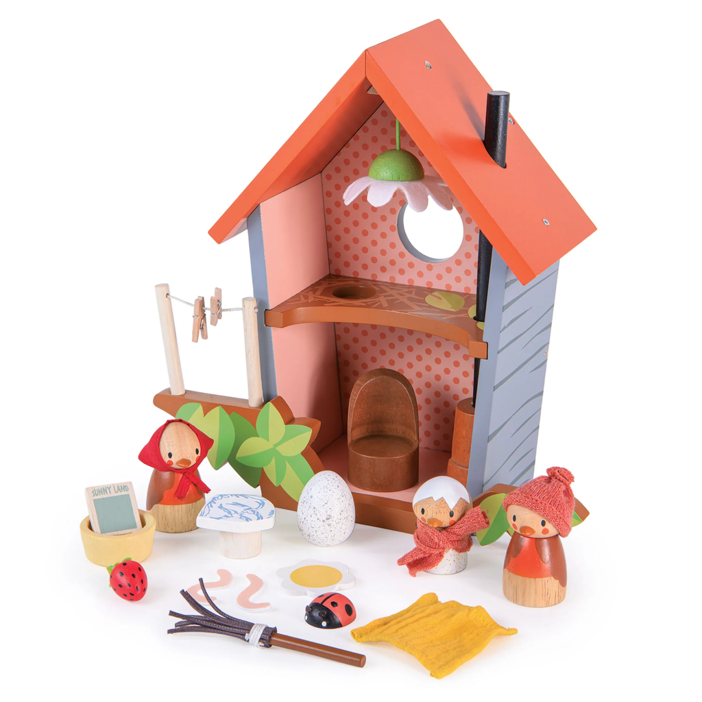 A wooden play set featuring a cozy birdhouse with nesting accessories, perfect for nurturing imaginative play and storytelling.