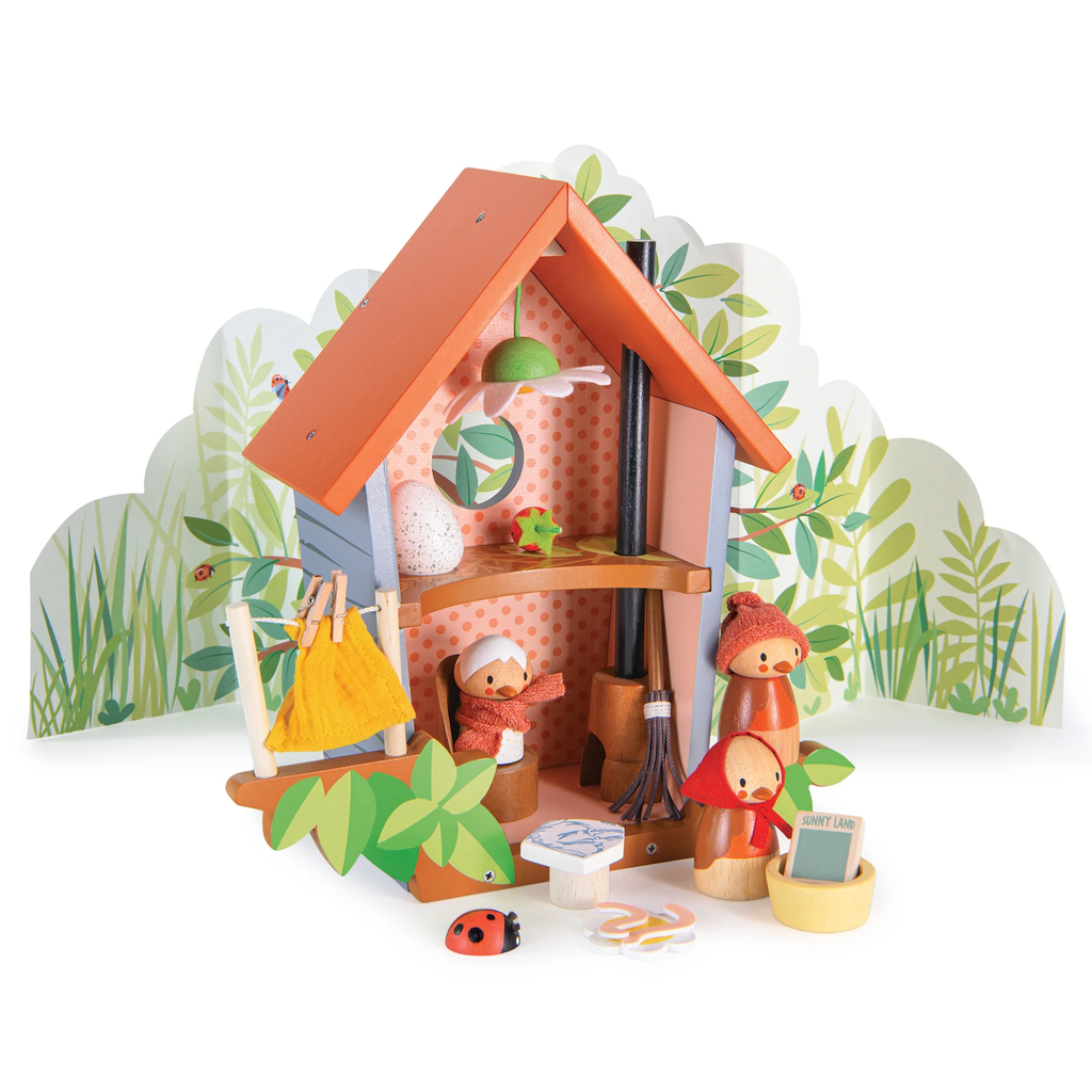 A wooden play set featuring a cozy birdhouse with nesting accessories, perfect for nurturing imaginative play and storytelling.