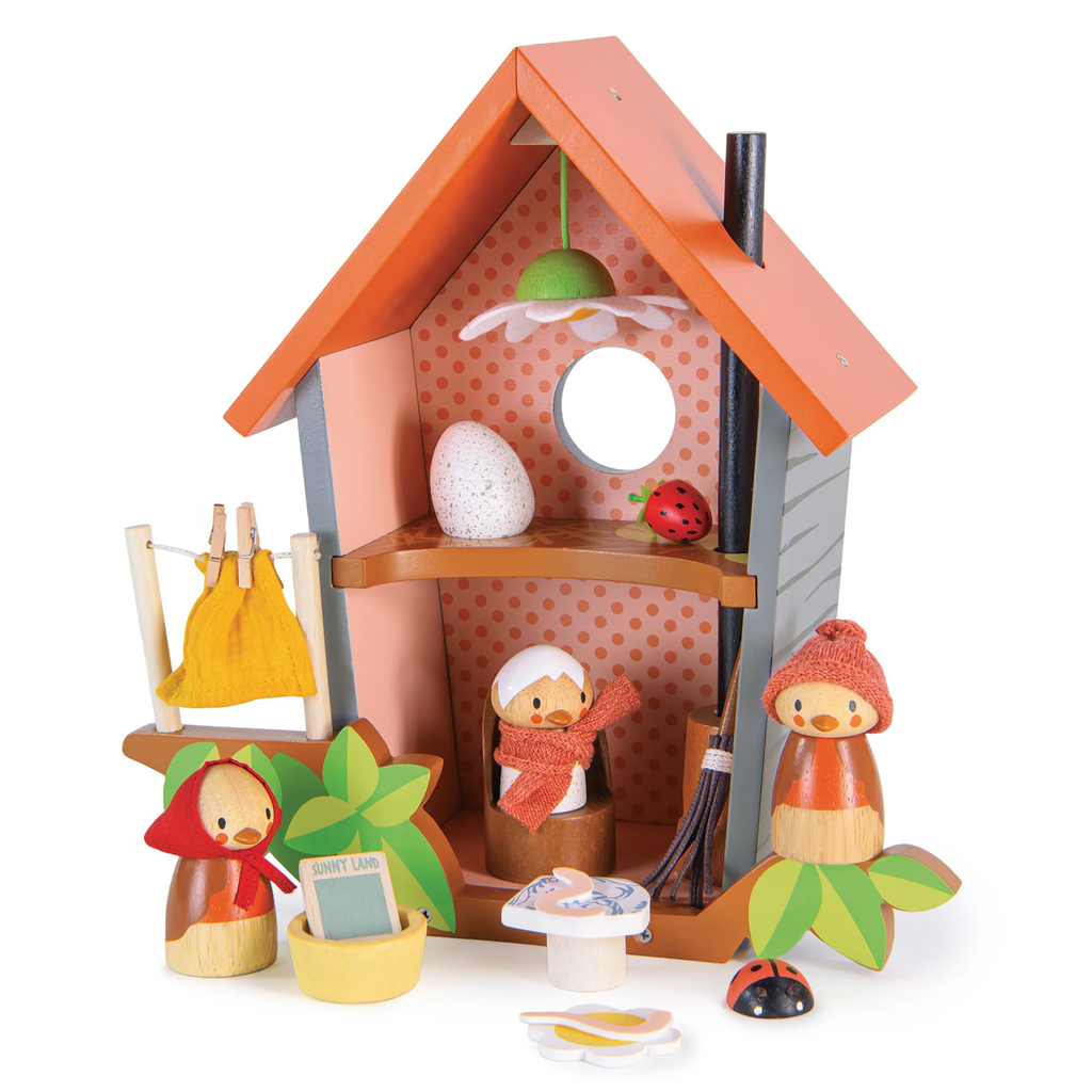 A wooden play set featuring a cozy birdhouse with nesting accessories, perfect for nurturing imaginative play and storytelling.