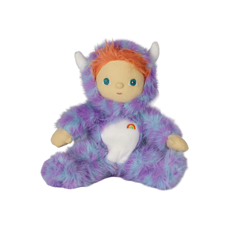 Seated plush doll in a fuzzy purple monster suit with white horns, orange hair, and a rainbow.