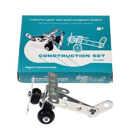 Toy aeroplane construction set with metal parts displayed in front of a teal box. The box includes assembly instructions and is for ages 8+.
