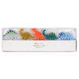 Boxed set of five Meri Meri dinosaur-shaped birthday candles on wooden picks in colorful shades.