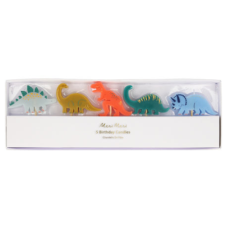 Boxed set of five Meri Meri dinosaur-shaped birthday candles on wooden picks in colorful shades.
