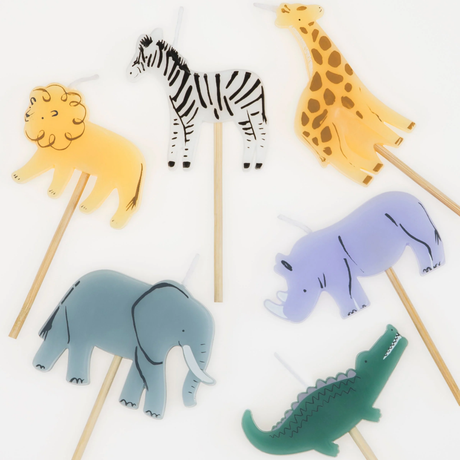 Close-up top view of six safari animal birthday candles featuring a lion, zebra, giraffe, elephant, rhino, and crocodile.