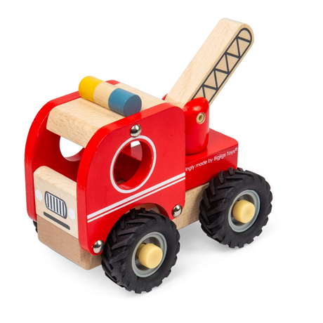 Wooden toy fire truck in bright red with black wheels on sandy ground. The playful setting evokes a cheerful and imaginative tone.