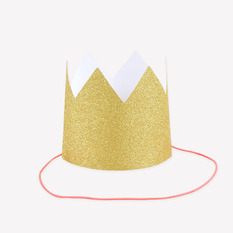 Mini gold glitter party crown with a pink elastic chin band set against a white background.